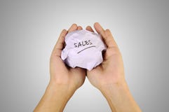 Hand Holding Crumpled Paper With Sales Writing Royalty Free Stock Images