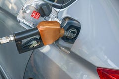 Hand holding fuel nozzle and refuel car royalty free stock photo Hand holding fuel nozzle and refuel car royalty free stock photo