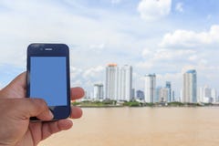 Hand Holding Mobile Phone with City Background royalty free stock image Hand Holding Mobile Phone with City Background royalty free stock image