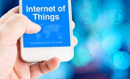 Hand holding mobile phone with Internet of Things word with related icon on blur blue motion background,Digital Marketing concept royalty free stock photography Hand holding mobile phone with Internet of Things word with related icon on blur blue motion background,Digital Marketing concept royalty free stock photography