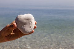 Hand holding a natural heart-shaped stone stock photo Hand holding a natural heart-shaped stone stock photo