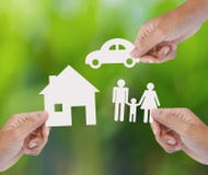 Hand holding paper home, car, family on green background stock photos Hand holding paper home, car, family on green background stock photos