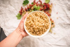 Hand holding white currant berries in a bowl stock photos Hand holding white currant berries in a bowl stock photos