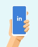 Hand holds the smartphone with LinkedIn application on the screen. Flat vector modern phone mock-up illustration stock illustration Hand holds the smartphone with LinkedIn application on the screen. Flat vector modern phone mock-up illustration stock illustration