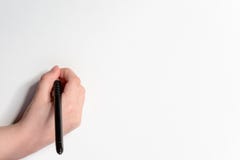 Hand of a little boy with a black pen on a white background stock images Hand of a little boy with a black pen on a white background stock images