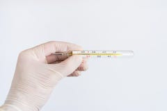 Hand in medical glove holding a thermometer isolated on white ba royalty free stock photos Hand in medical glove holding a thermometer isolated on white ba royalty free stock photos