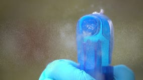 Hand with medical gloves Spray disinfectant Liquid on Coronavirus Title
