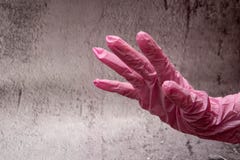 hand with nitrile gloves on gray background