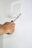 Hand with paint roller and grey paint stock photography Hand with paint roller and grey paint stock photography
