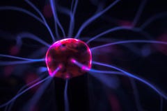 Hand and plasma ball flames on a black background