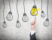 Hand pointing to lightbulb Stock Photo Hand pointing to lightbulb Stock Photo