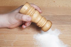 Hand putting some salt shaker Stock Images Hand putting some salt shaker Stock Images
