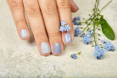 Hand with short manicured nails colored with gray nail polish stock images Hand with short manicured nails colored with gray nail polish stock images