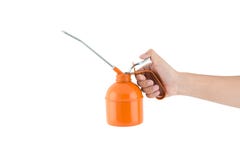 Hand som rymmer canen för orange olja arkivbild Hand som rymmer canen för orange olja arkivbild