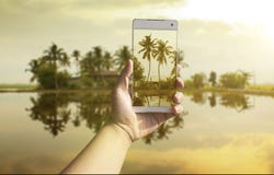 Hand taking photo of the fish village landscape stock photography Hand taking photo of the fish village landscape stock photography