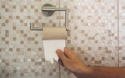 Hand with torn toilet paper royalty free stock photo Hand with torn toilet paper royalty free stock photo