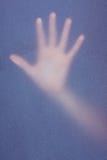 Hand touching frosted glass. In the shadow Stock Photo Hand touching frosted glass. In the shadow Stock Photo