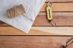Hand weights, string and wrapping paper on natural wooden background. stock photos Hand weights, string and wrapping paper on natural wooden background. stock photos