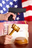 Hand With Gun And Judges Gavel Royalty Free Stock Images