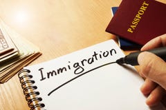 Hand is writing Immigration. stock images Hand is writing Immigration. stock images
