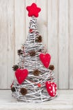 Handmade Christmas tree with red heart as decor made of vine for white interior. stock images Handmade Christmas tree with red heart as decor made of vine for white interior. stock images