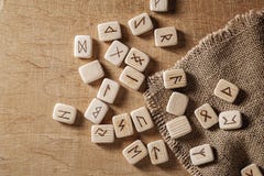 Handmade scandinavian wooden runes on a wooden vintage background. Concept of fortune telling and prediction of the stock photo Handmade scandinavian wooden runes on a wooden vintage background. Concept of fortune telling and prediction of the stock photo