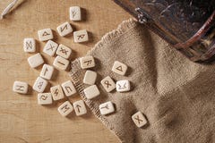 Handmade scandinavian wooden runes on a wooden vintage background. Concept of fortune telling and prediction of the royalty free stock images Handmade scandinavian wooden runes on a wooden vintage background. Concept of fortune telling and prediction of the royalty free stock images
