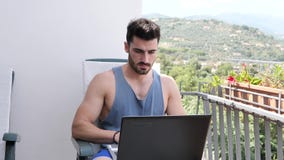 Handosme-Mann, der zu Hause am Computertisch arbeitet stock footage Handosme-Mann, der zu Hause am Computertisch arbeitet stock footage
