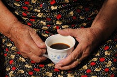 Hands Around A Coffee Cup Stock Photos