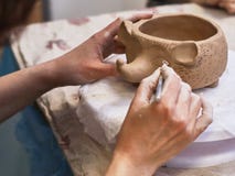 Hands in clay make a ceramic bowl stock photo Hands in clay make a ceramic bowl stock photo