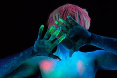 Hands and hair of a girl model painted with neon colored paints in the light of ultraviolet lamps. stock images Hands and hair of a girl model painted with neon colored paints in the light of ultraviolet lamps. stock images