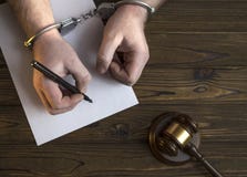 Hands in handcuffs and a hammer of the judge. royalty free stock photography Hands in handcuffs and a hammer of the judge. royalty free stock photography