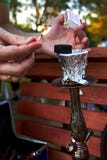 Hands holding matches and burning coal for hookah in the park royalty free stock photos Hands holding matches and burning coal for hookah in the park royalty free stock photos