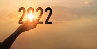 Hands holding of new year 2022 silhouette against on the sunset background, Happy New Year concept