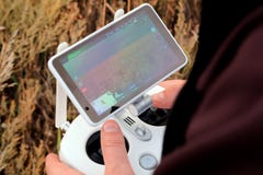 Hands of a man on the joystick control panel of an unmanned aerial vehicle. The farmer controls the drones and sees a field with a stock images Hands of a man on the joystick control panel of an unmanned aerial vehicle. The farmer controls the drones and sees a field with a stock images