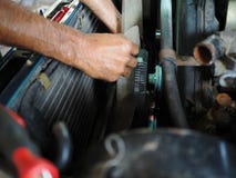 Hands of mechanic checking cooling fan of car in garage. Auto repair service. Stock Photos Hands of mechanic checking cooling fan of car in garage. Auto repair service. Stock Photos