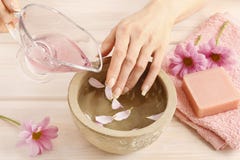 Hands over ceramic bowl with water and essential oils royalty free stock photography Hands over ceramic bowl with water and essential oils royalty free stock photography