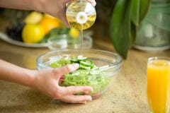 Hands Pouring Oil In A Green Salad Stock Images Hands Pouring Oil In A Green Salad Stock Images