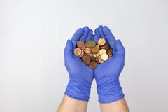 Hands with protection gloves holding Spanish Euro cent coins