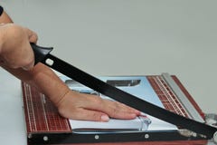 Hands take to cut the paper by using wooden guillotine paper trimmer . stock photography Hands take to cut the paper by using wooden guillotine paper trimmer . stock photography