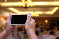 Hands of unidentified people taking photo of dinner party with mobile smart phone with blank screen stock photography Hands of unidentified people taking photo of dinner party with mobile smart phone with blank screen stock photography