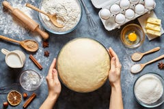 Hands working with dough preparation recipe bread, pizza or pie making ingridients, food flat lay