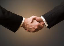 Handshake. Business handshake with brown background Handshake. Business handshake with brown background