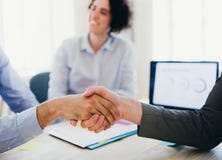 Handshake of male businesspeople in an office. Midsection. stock image Handshake of male businesspeople in an office. Midsection. stock image
