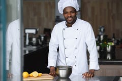 handsome african american chef standing near kitchen counter