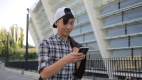 Handsome Asian student man typing smartphone urban Downtown Night Lights Communication Technology 4G Reception Texting stock footage Handsome Asian student man typing smartphone urban Downtown Night Lights Communication Technology 4G Reception Texting stock footage