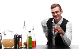 A handsome bartender holds a shot, oranges, bottles of beverages on a white background. stock photo A handsome bartender holds a shot, oranges, bottles of beverages on a white background. stock photo