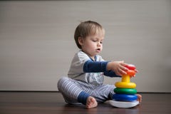 A handsome boy collects a pyramid. royalty free stock image A handsome boy collects a pyramid. royalty free stock image