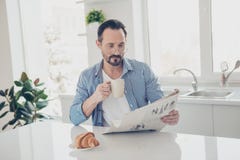 Handsome brunet hair man in trendy style checkered shirt sit ins stock photography Handsome brunet hair man in trendy style checkered shirt sit ins stock photography
