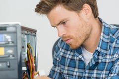 Handsome computer engineer repairing faulty pc Royalty Free Stock Photo Handsome computer engineer repairing faulty pc Royalty Free Stock Photo